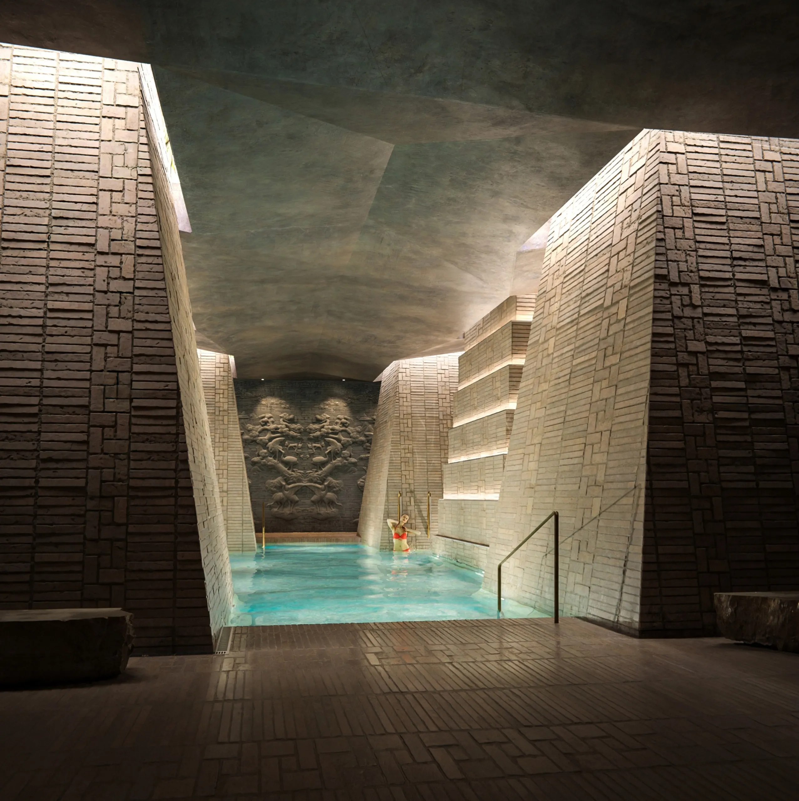 Interior pool with brick walls and carved relief