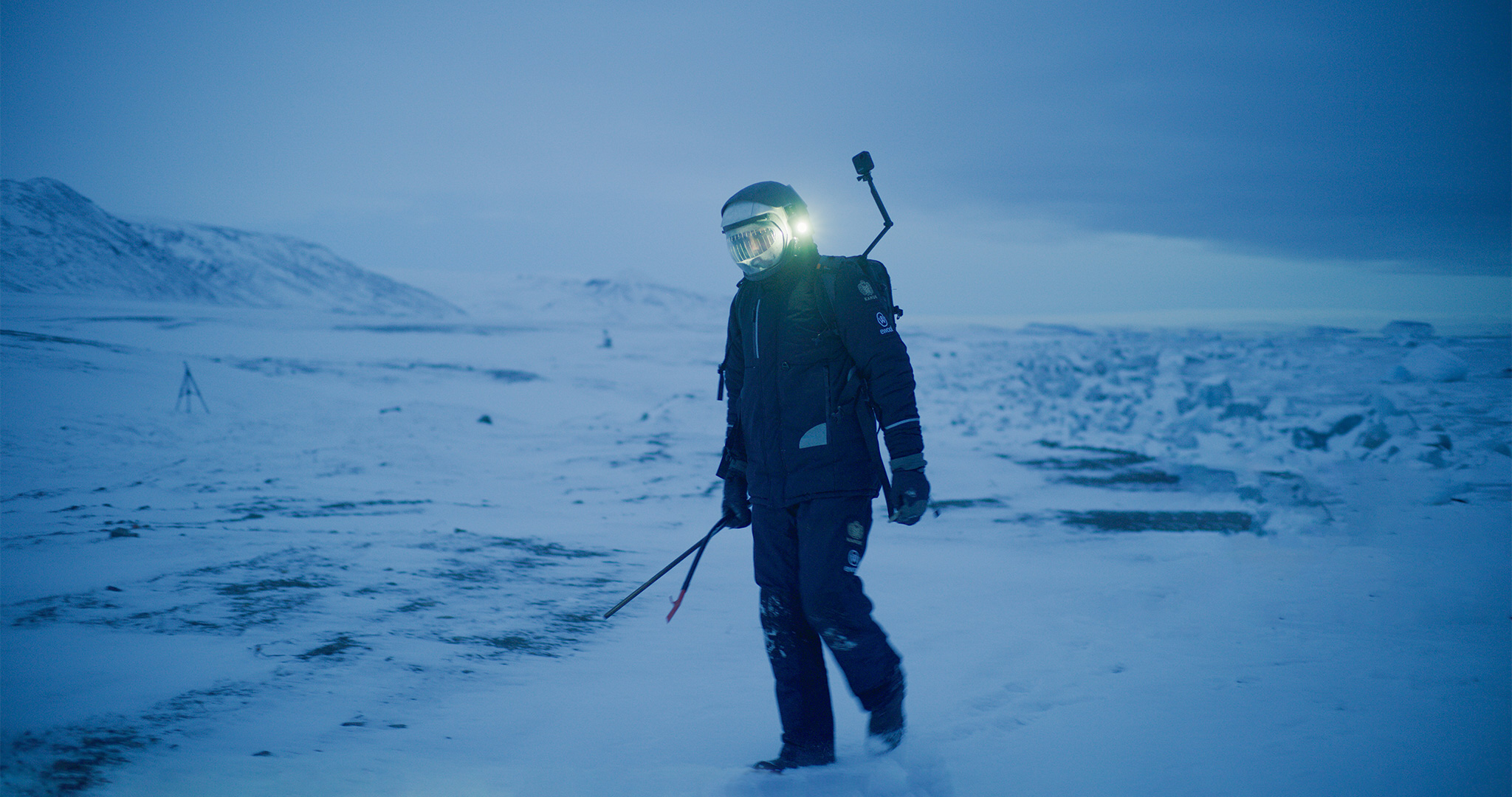 Simulation astronaut walking outside in the monotonous snowy landscape