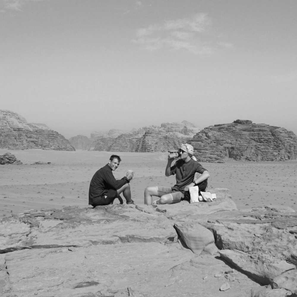 Sebastian and Karl sitting in the Wadi Rum desert.